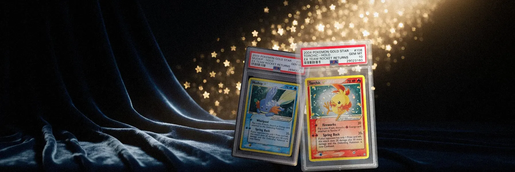 2004 Pokémon Gold Star Torchic and Mudkip, both PSA 10, standing on midnight velvet under a shower of golden stars